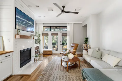 a living room with furniture fireplace and flat screen tv