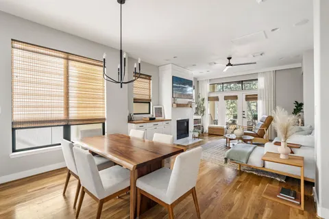 a dining room with furniture and wooden floor