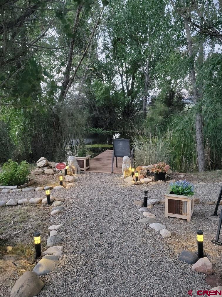 21043 Road C 7 Cortez Co 81321 Cortez, CO 81321 - Photo 26 of 40 a view of backyard with a table and chairs under an umbrella