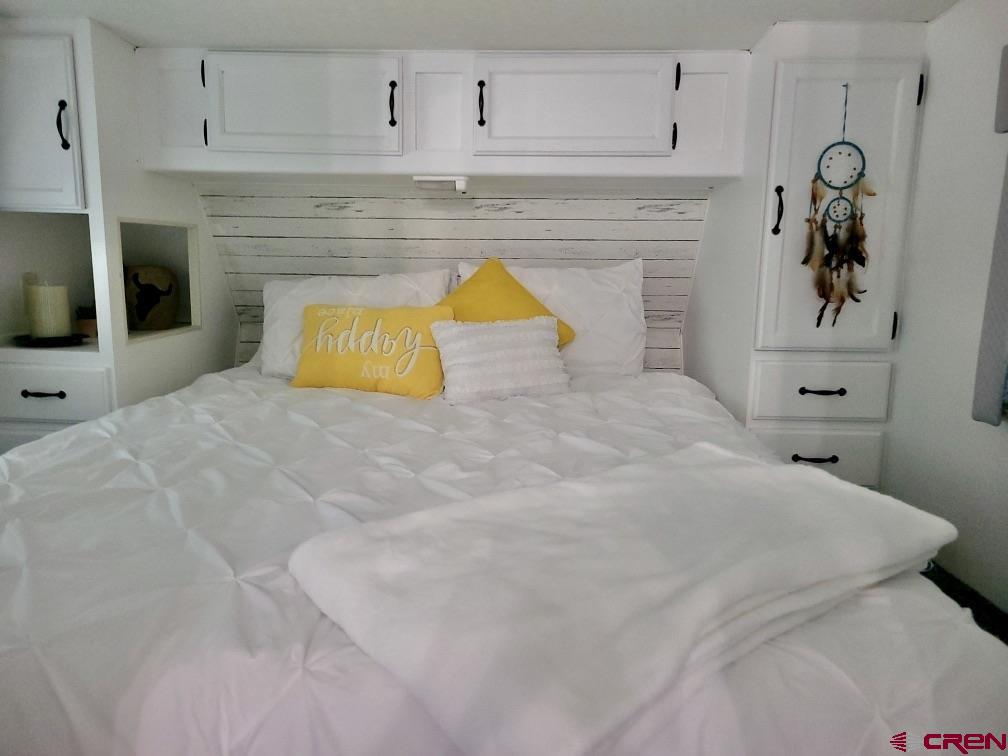 21043 Road C 7 Cortez Co 81321 Cortez, CO 81321 - Photo 33 of 40 a bedroom with a bed and a fireplace