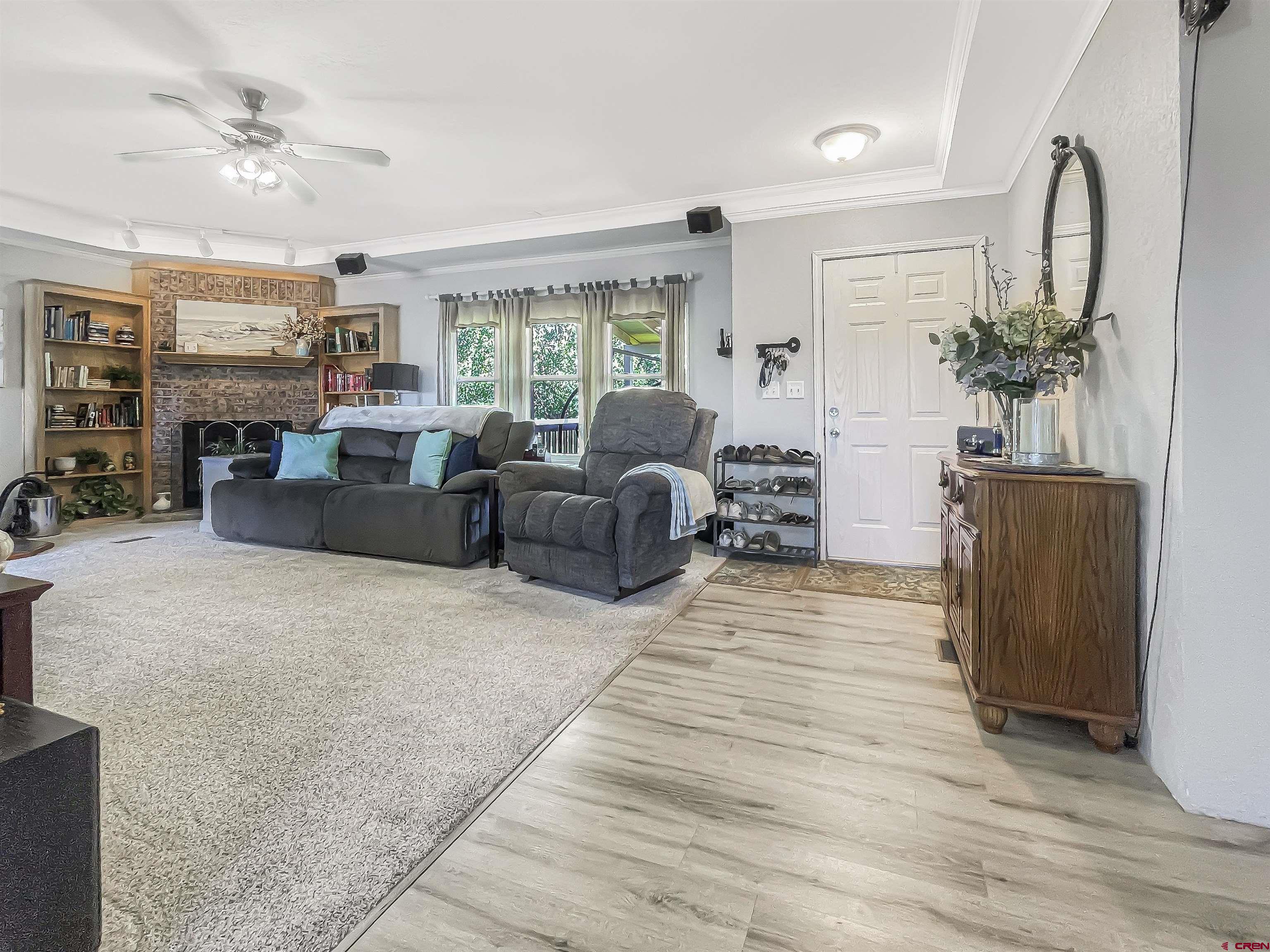 21043 Road C 7 Cortez Co 81321 Cortez, CO 81321 - Photo 5 of 40 a living room with furniture fireplace and a large window
