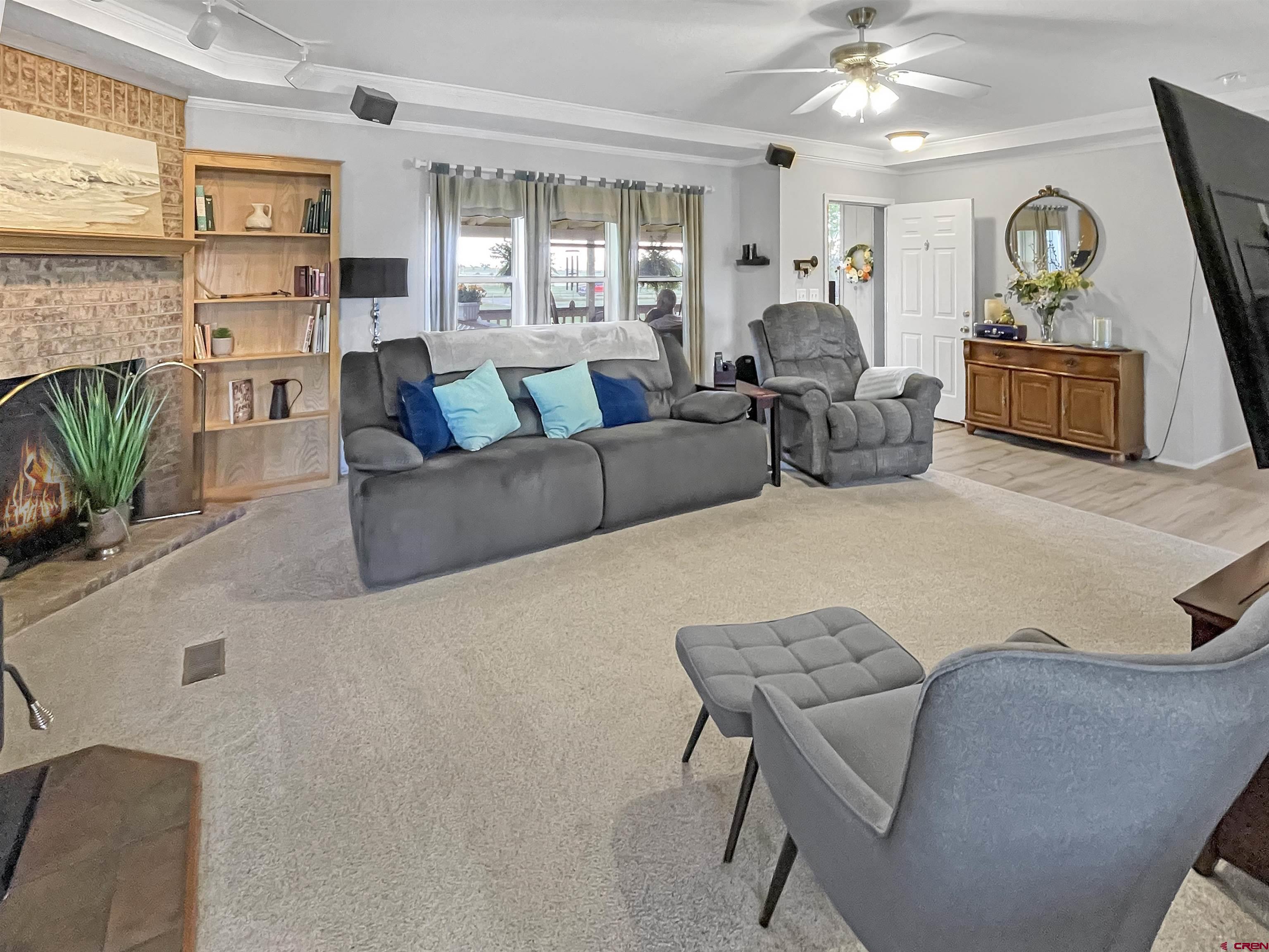 21043 Road C 7 Cortez Co 81321 Cortez, CO 81321 - Photo 6 of 40 a living room with furniture and a flat screen tv