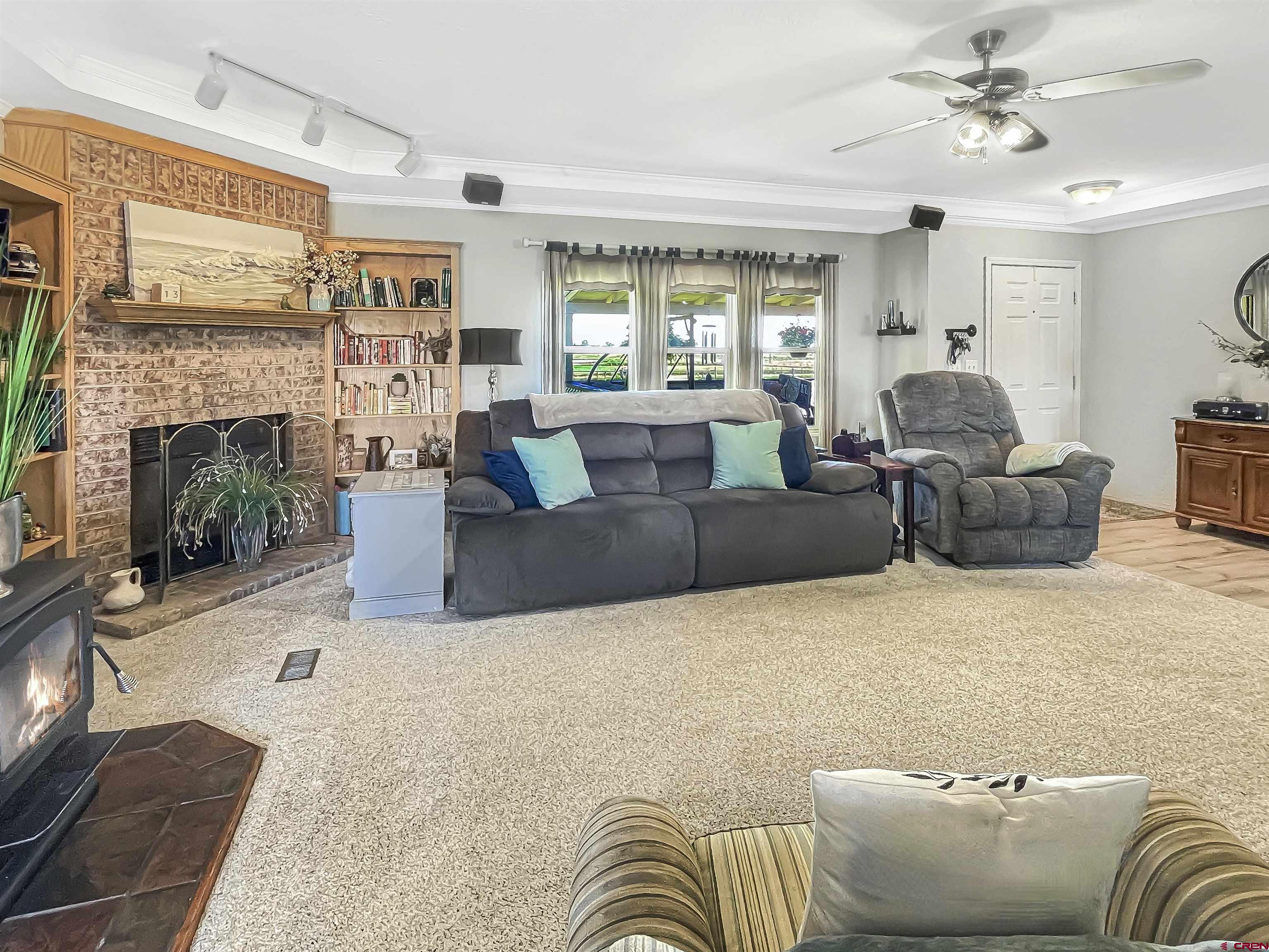 21043 Road C 7 Cortez Co 81321 Cortez, CO 81321 - Photo 8 of 40 a living room with furniture and a fireplace