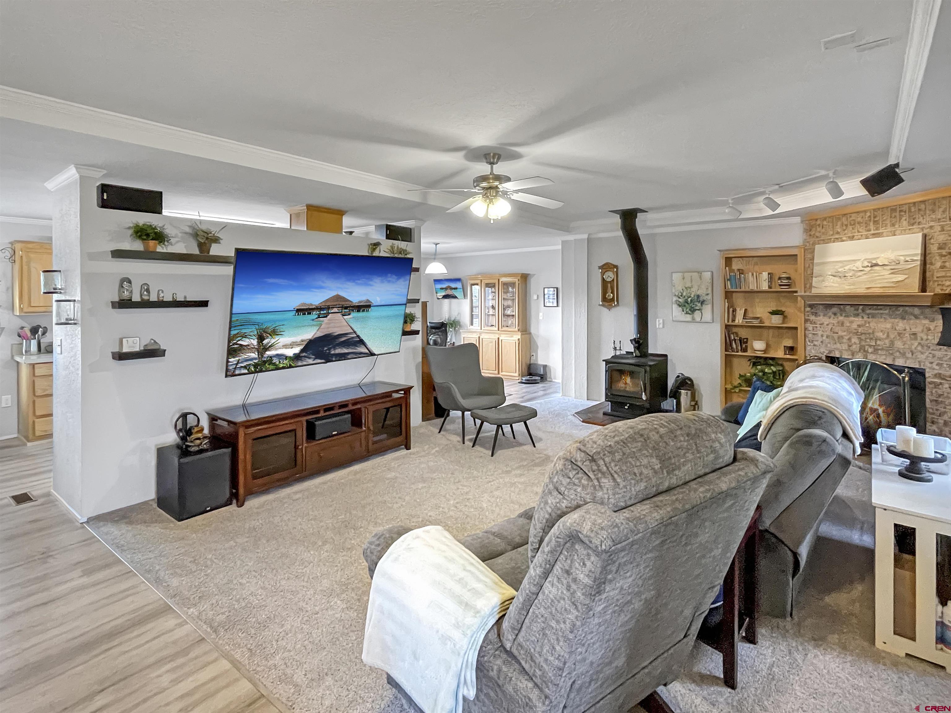 21043 Road C 7 Cortez Co 81321 Cortez, CO 81321 - Photo 9 of 40 a living room with furniture a fireplace and a flat screen tv