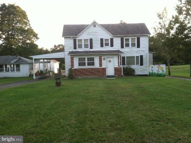 45349 Happyland Road Valley Lee, MD 20692 - Photo 1 of 4 a front view of a house with a garden and trees