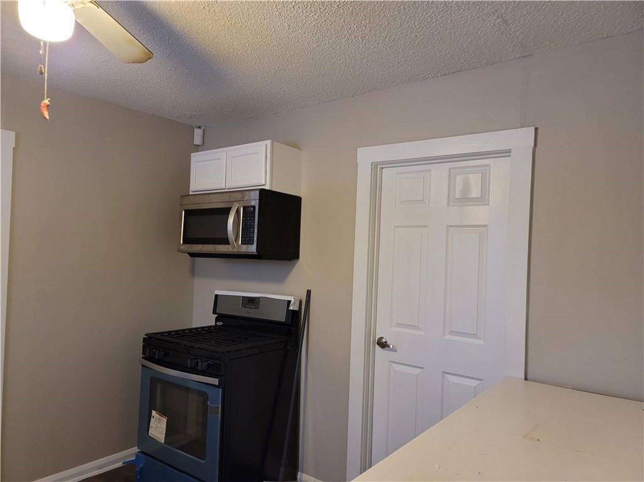 18501 Blake Manor Road Manor, TX 78653 - Photo 6 of 11 a kitchen with a sink and a microwave