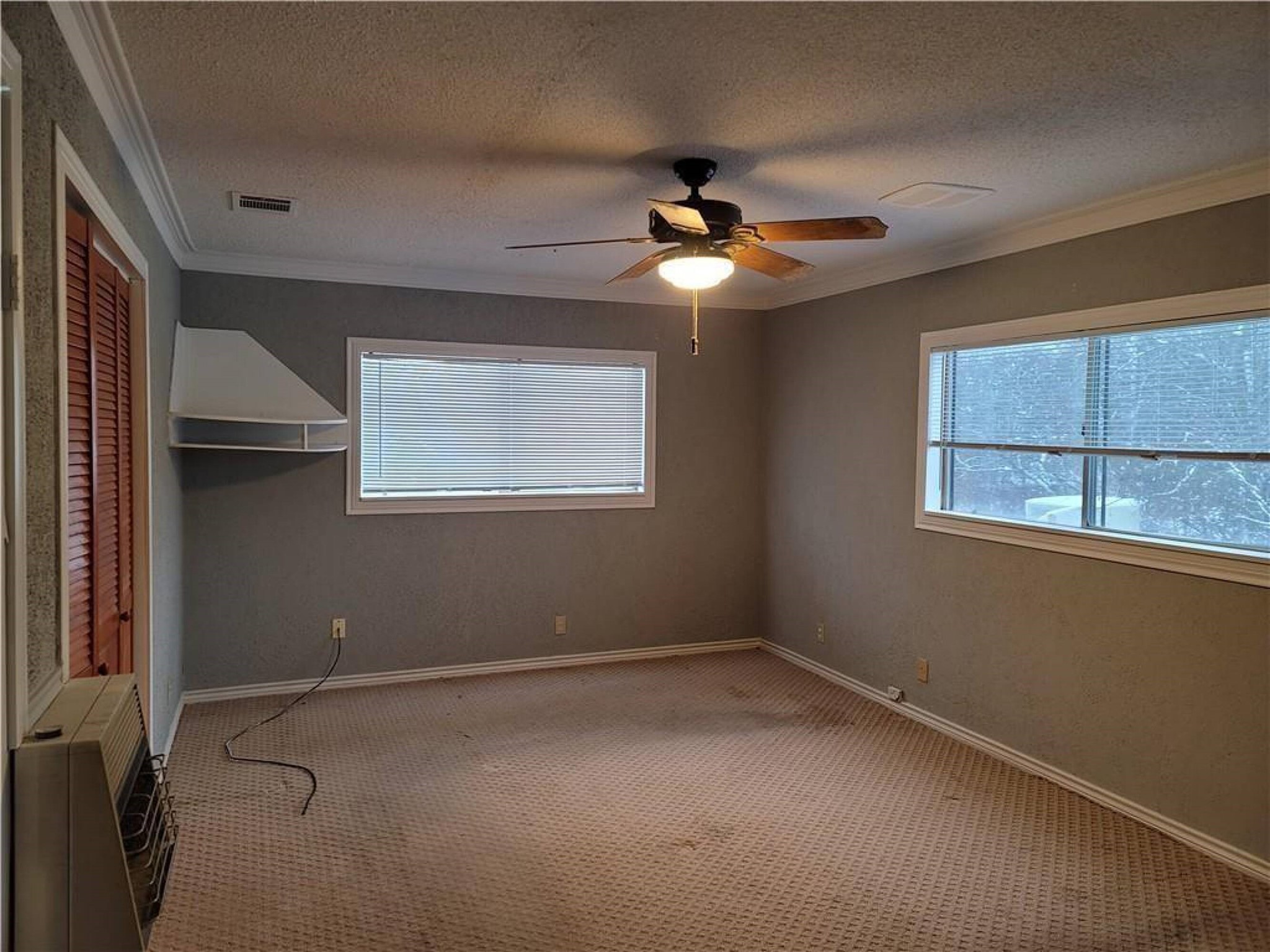 18501 Blake Manor Road Manor, TX 78653 - Photo 7 of 11 an empty room with windows and fan