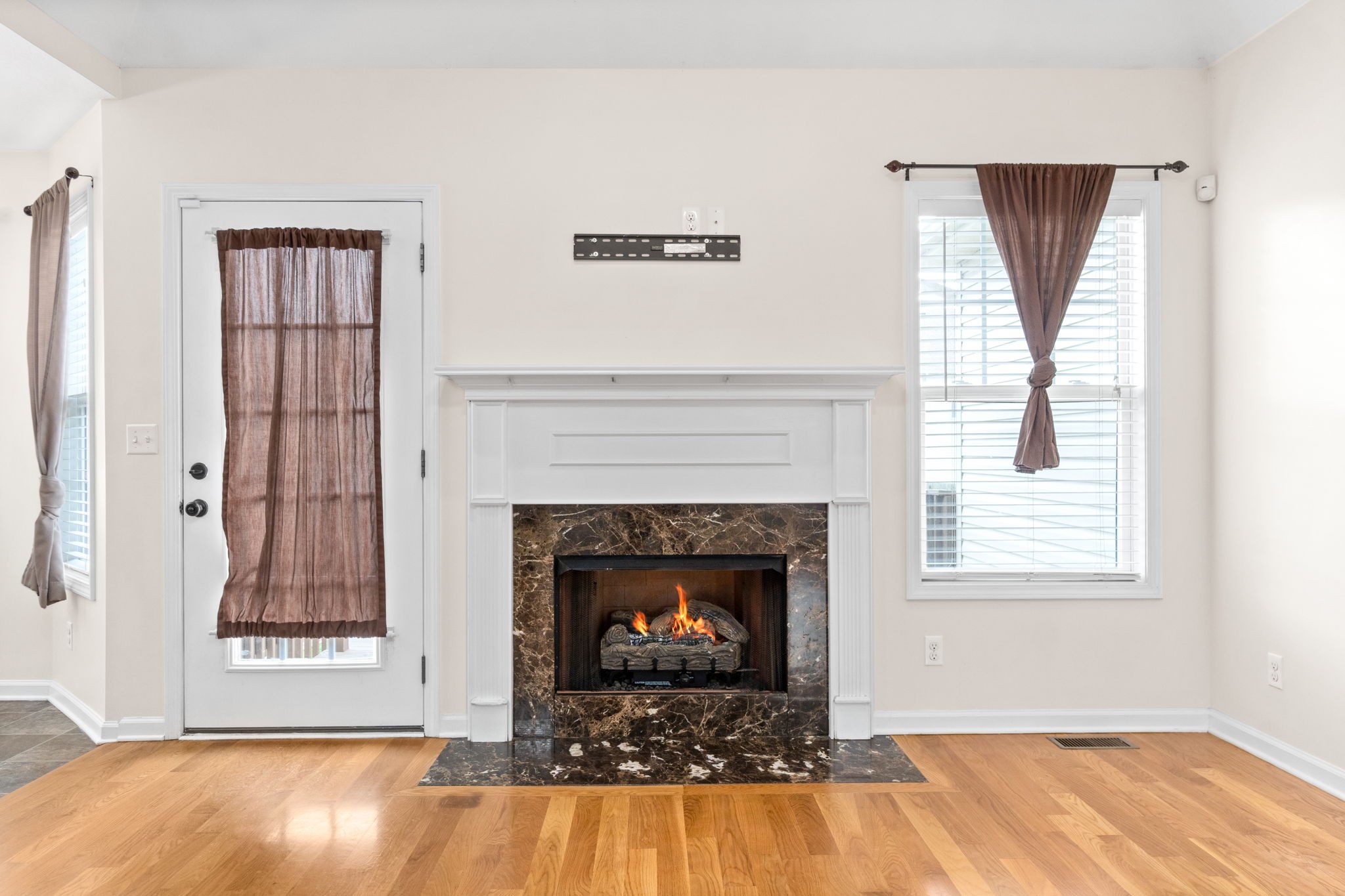 3753 Suiter Road Clarksville, TN 37040 - Photo 7 of 30 a living room with a fireplace and wooden floor