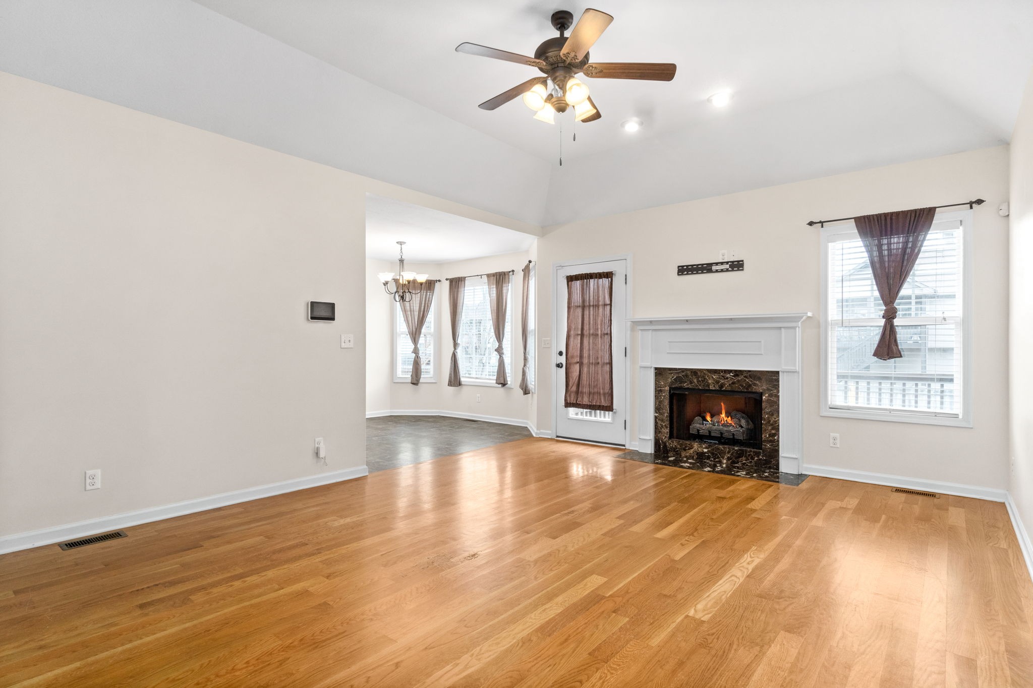 3753 Suiter Road Clarksville, TN 37040 - Photo 8 of 30 a view of empty room with wooden floor fireplace and a window