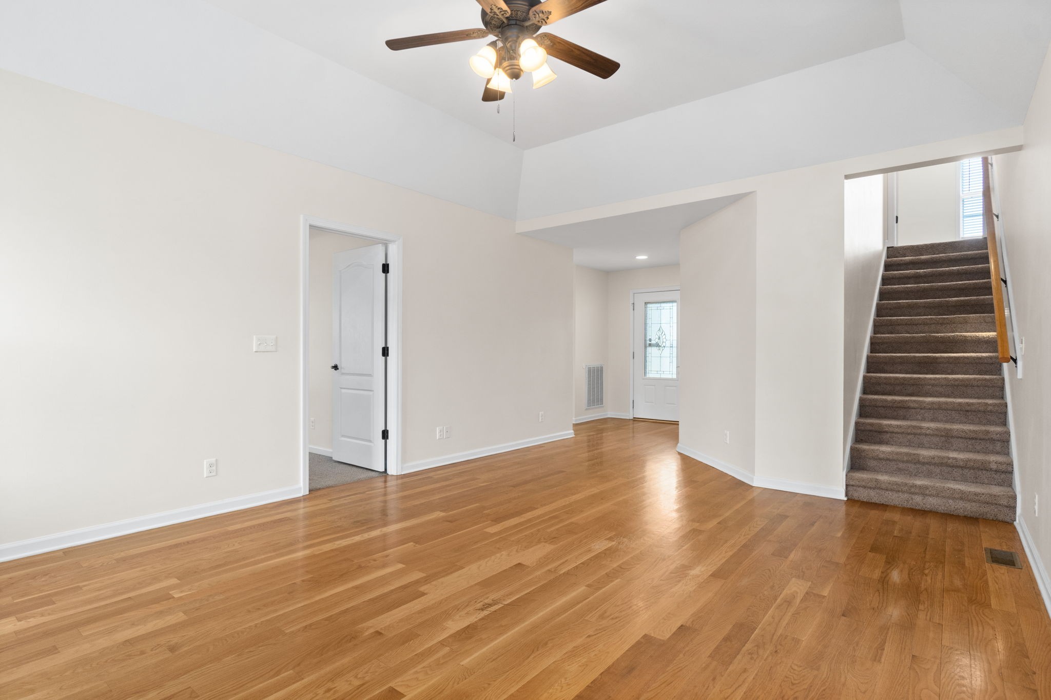 3753 Suiter Road Clarksville, TN 37040 - Photo 9 of 30 an empty room with wooden floor fan and windows