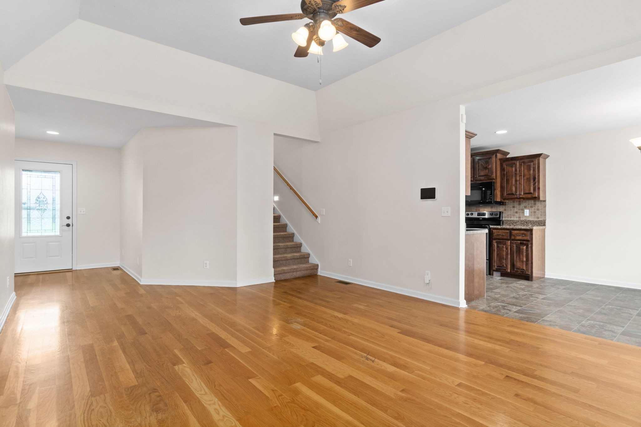 3753 Suiter Road Clarksville, TN 37040 - Photo 10 of 30 a view of a kitchen with wooden floor and a ceiling fan