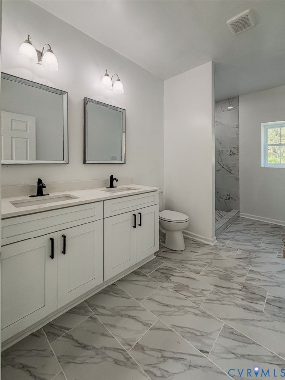 19614 Manson Church Road McKenney, VA 23872 - Photo 13 of 24 a bathroom with a double vanity sink a toilet and a mirror