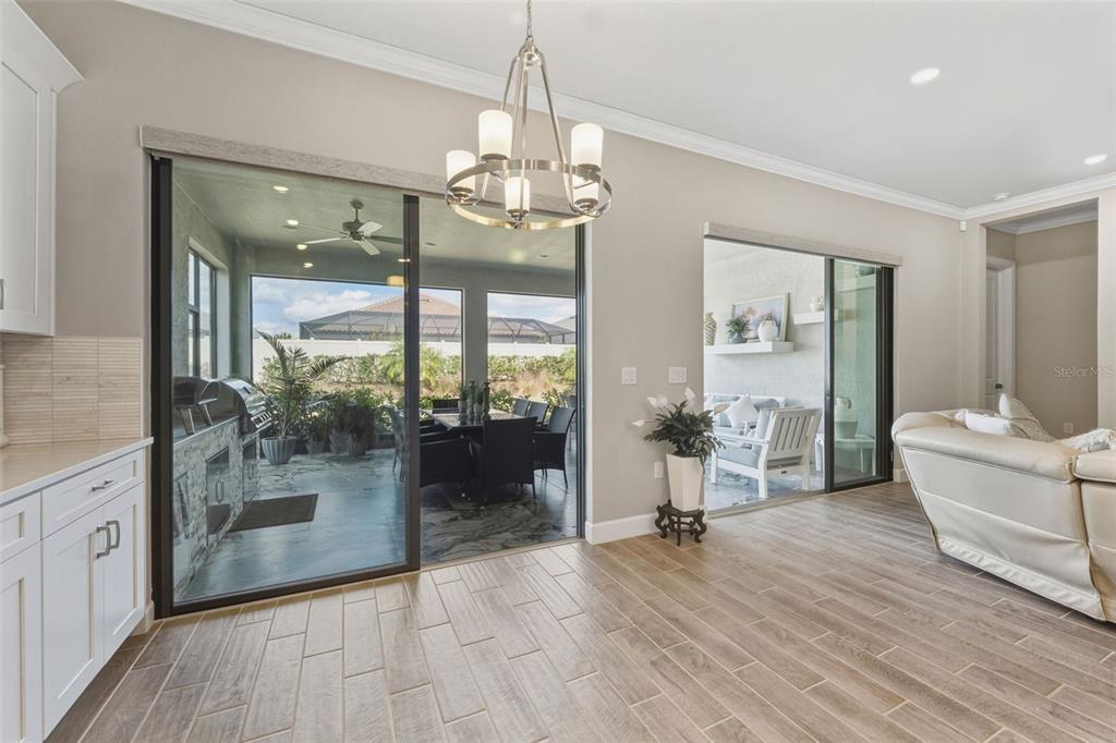 4951 Freccia Loop Wesley Chapel, FL 33543 - Photo 11 of 43 a living room with furniture and a chandelier