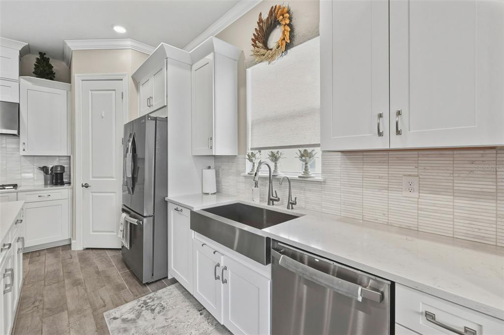 4951 Freccia Loop Wesley Chapel, FL 33543 - Photo 15 of 43 a kitchen with stainless steel appliances granite countertop a sink stove and refrigerator