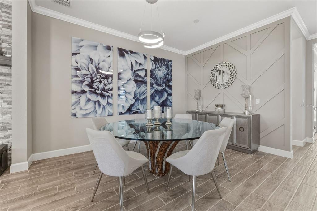 4951 Freccia Loop Wesley Chapel, FL 33543 - Photo 18 of 43 a view of a dining room with furniture and wooden floor