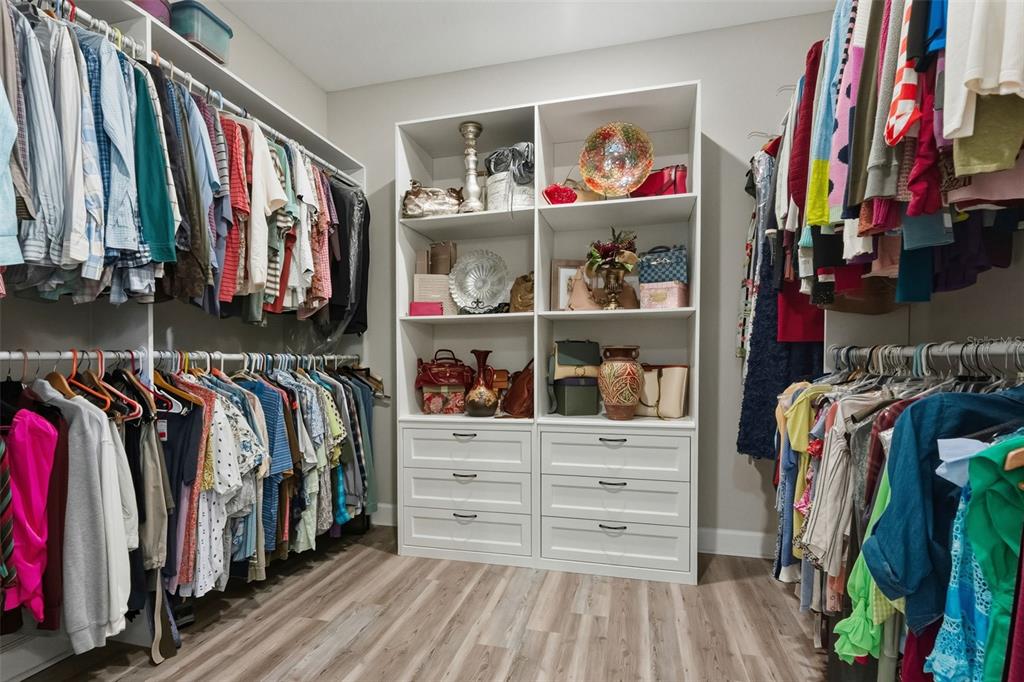 4951 Freccia Loop Wesley Chapel, FL 33543 - Photo 24 of 43 a view of walk in closet with clothes and shoes