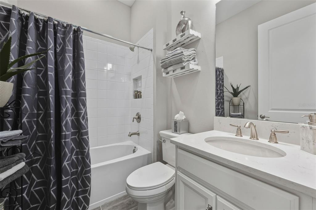 4951 Freccia Loop Wesley Chapel, FL 33543 - Photo 27 of 43 a bathroom with a sink toilet and shower