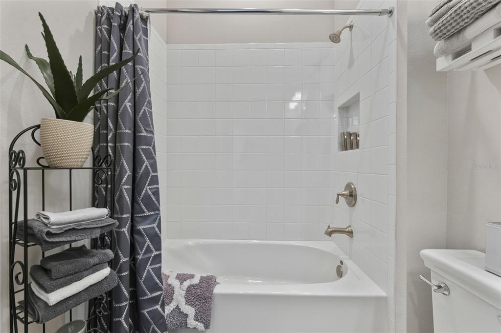 4951 Freccia Loop Wesley Chapel, FL 33543 - Photo 28 of 43 a bathroom with a bathtub a sink and a toilet