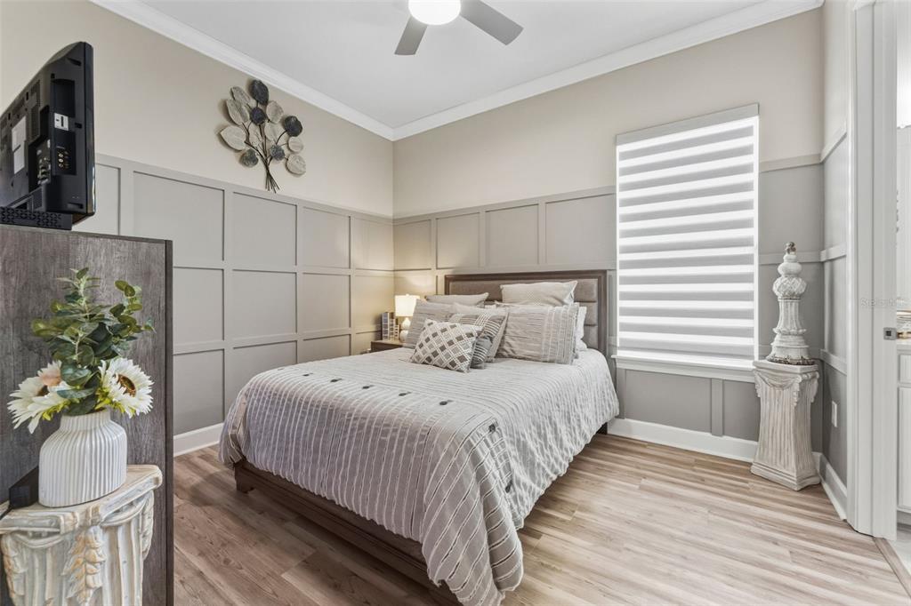 4951 Freccia Loop Wesley Chapel, FL 33543 - Photo 29 of 43 a bedroom with bed and a chandelier