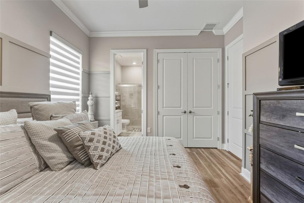 4951 Freccia Loop Wesley Chapel, FL 33543 - Photo 30 of 43 a bedroom with furniture and a flat screen tv