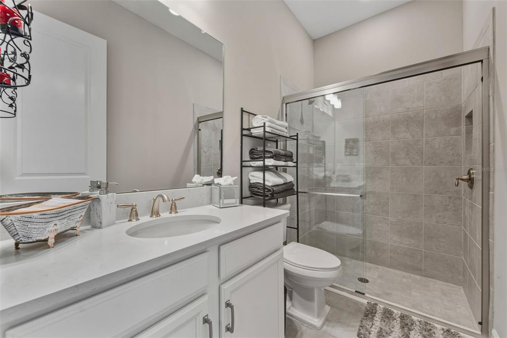 4951 Freccia Loop Wesley Chapel, FL 33543 - Photo 31 of 43 a bathroom with a sink toilet and shower