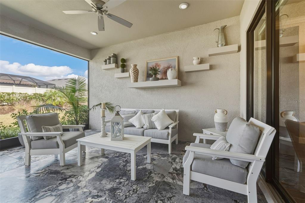 4951 Freccia Loop Wesley Chapel, FL 33543 - Photo 37 of 43 a living room with furniture and a large window