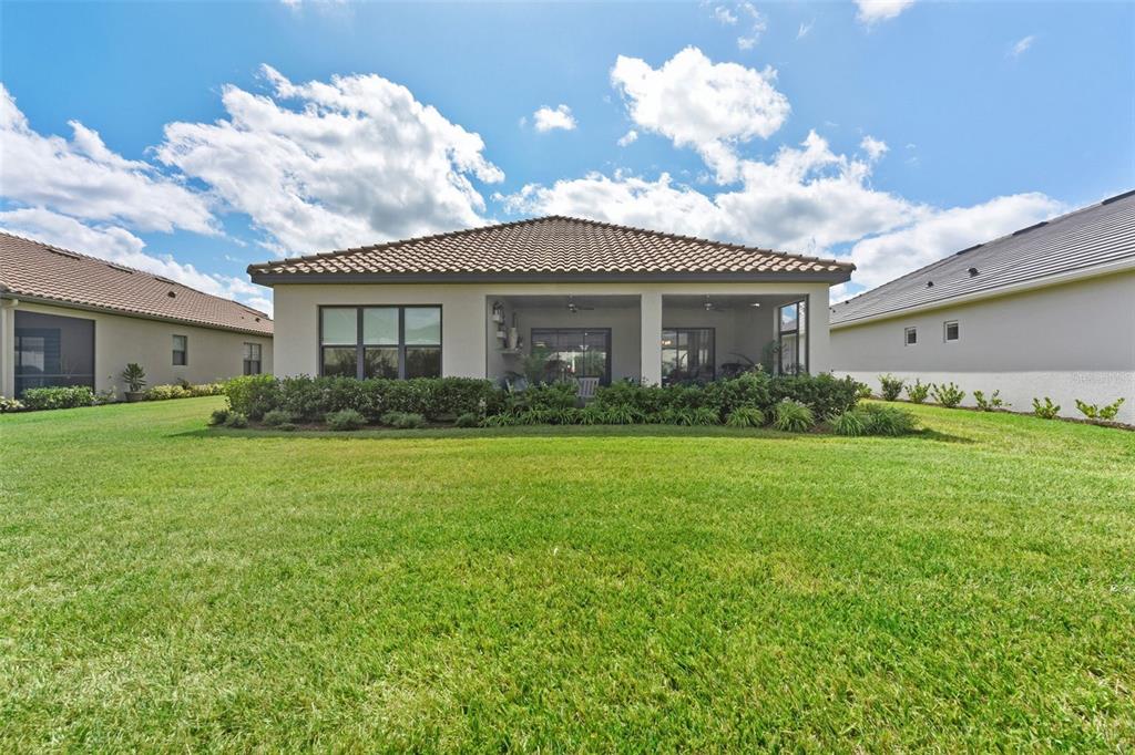 4951 Freccia Loop Wesley Chapel, FL 33543 - Photo 40 of 43 a front view of house with garden