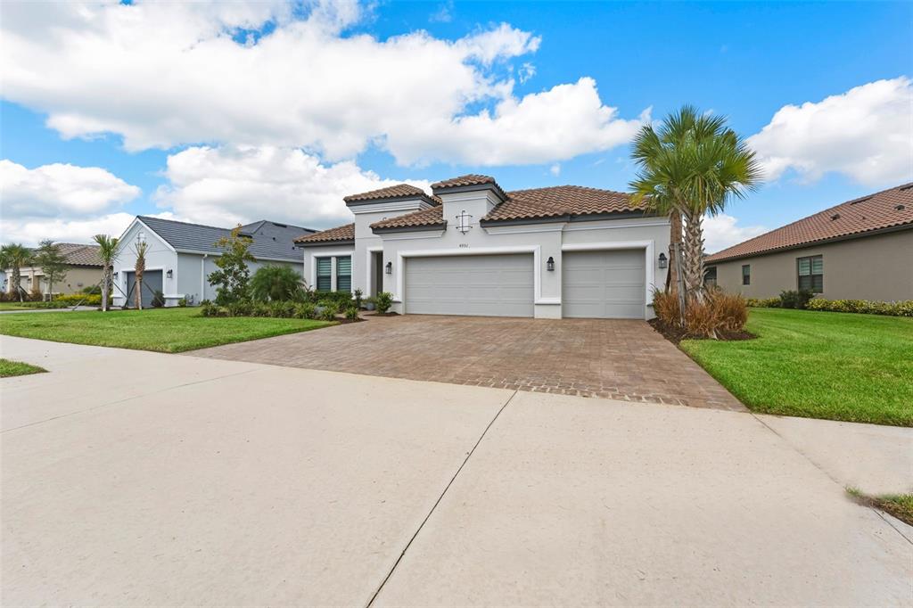 4951 Freccia Loop Wesley Chapel, FL 33543 - Photo 43 of 43 a front view of a house with a yard and garage