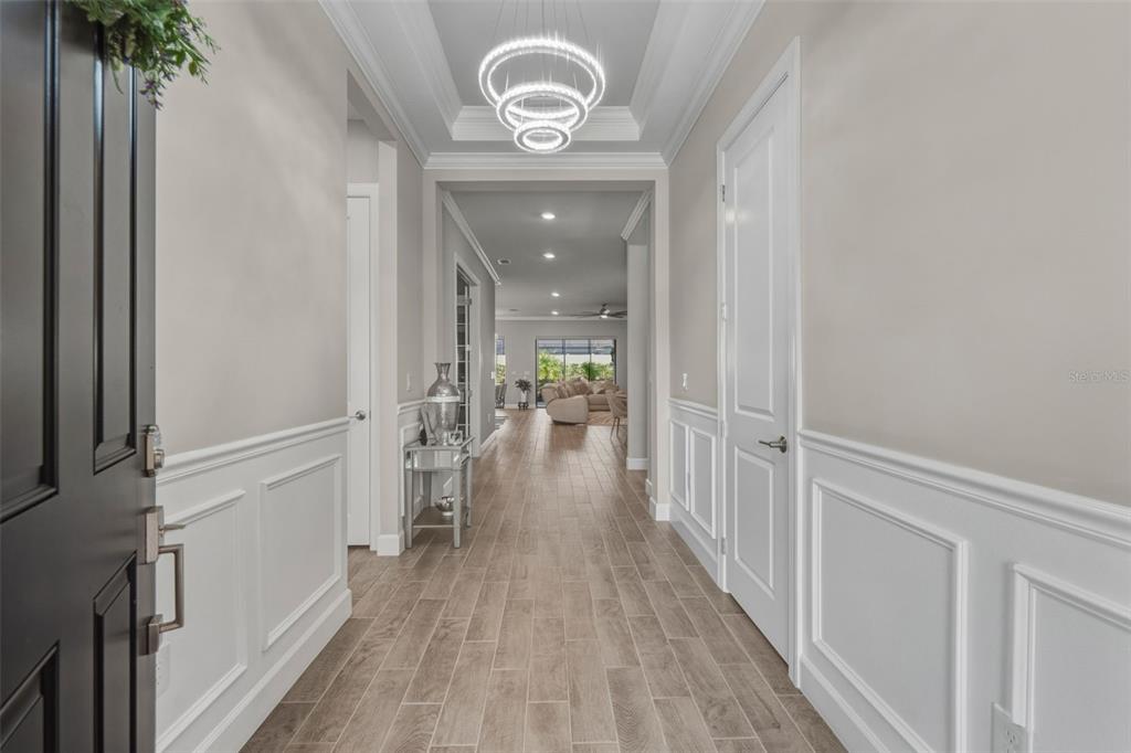 4951 Freccia Loop Wesley Chapel, FL 33543 - Photo 5 of 43 a view of hallway with wooden floor