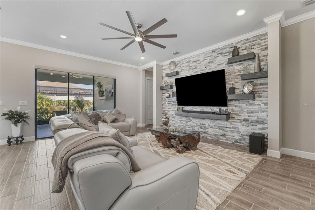 4951 Freccia Loop Wesley Chapel, FL 33543 - Photo 7 of 43 a living room with furniture and a flat screen tv