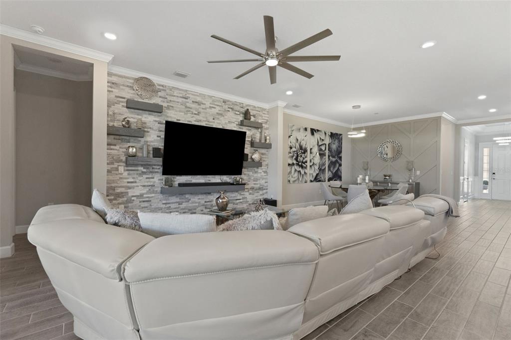 4951 Freccia Loop Wesley Chapel, FL 33543 - Photo 8 of 43 a living room with furniture and a flat screen tv