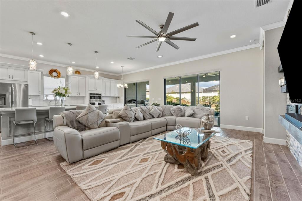 4951 Freccia Loop Wesley Chapel, FL 33543 - Photo 9 of 43 a living room with furniture a ceiling fan and a window