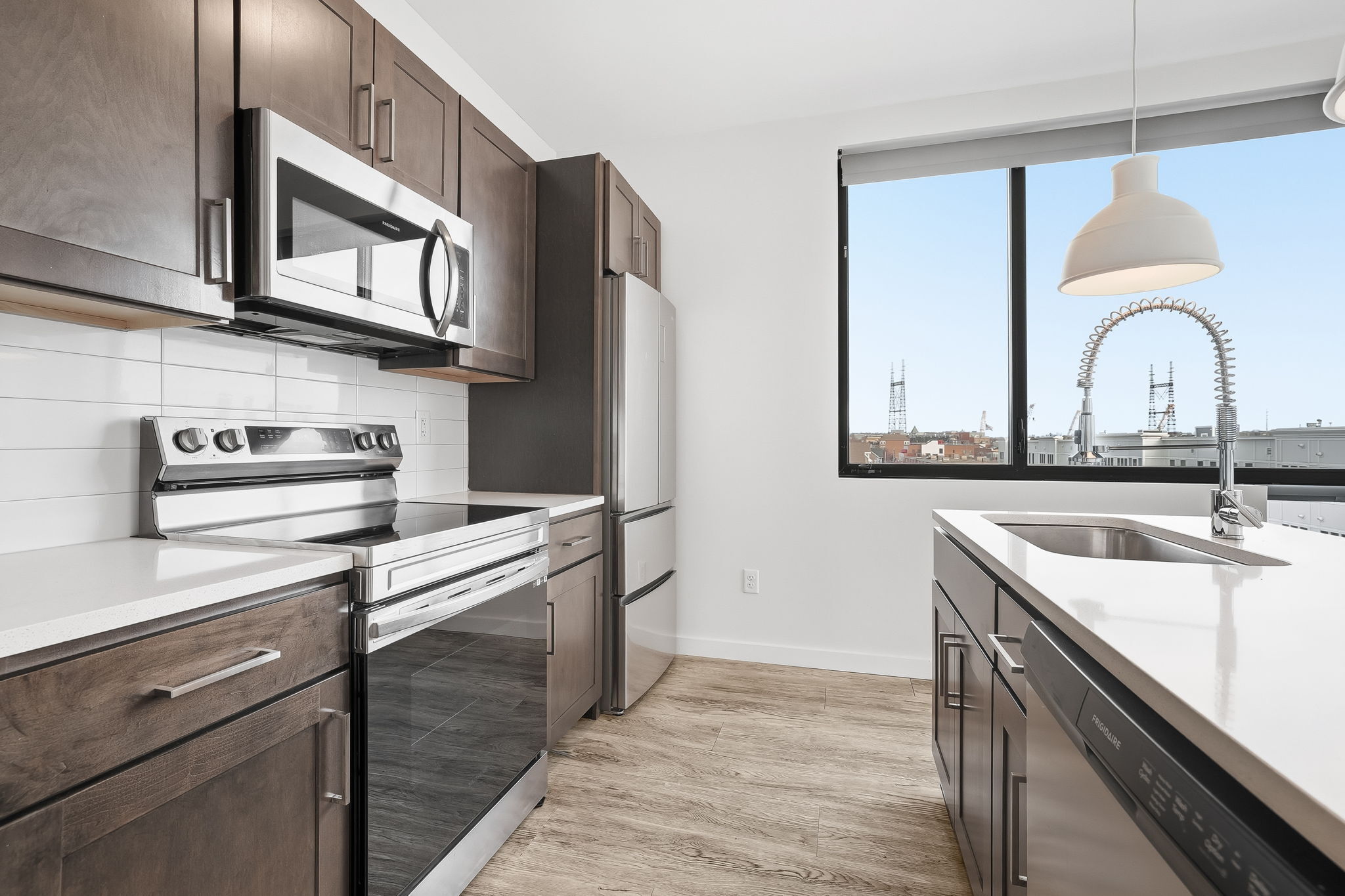 a kitchen with stainless steel appliances granite countertop a sink and cabinets