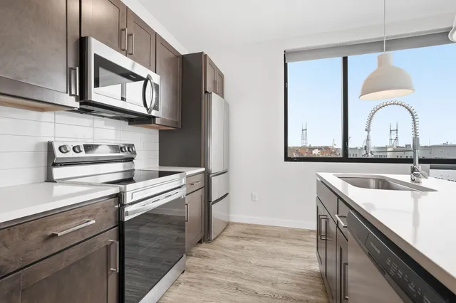 a kitchen with stainless steel appliances granite countertop a sink and cabinets