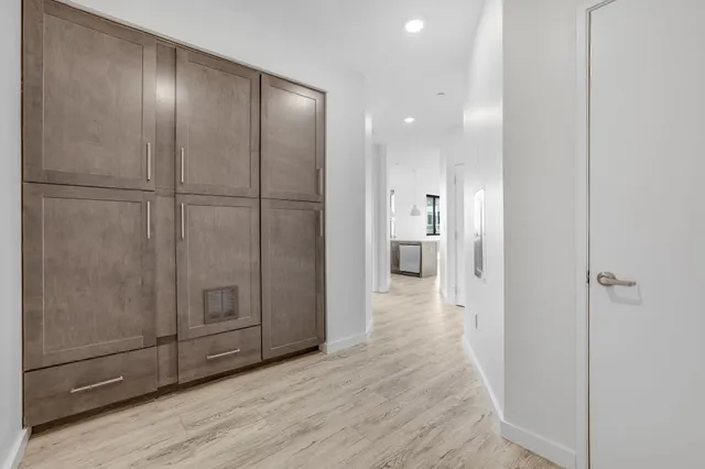 a view of a hallway with wooden floor