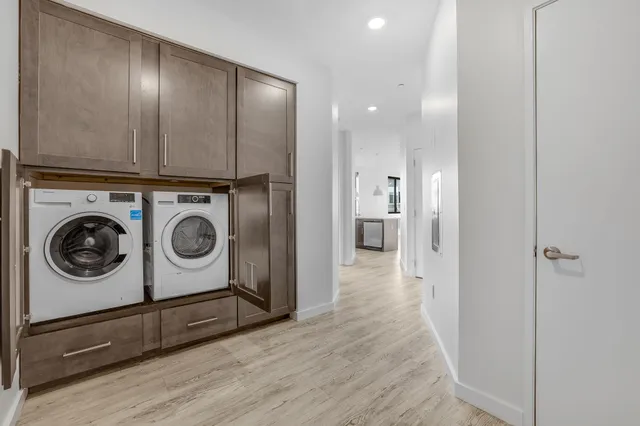 a view of a hallway with washer and dryer