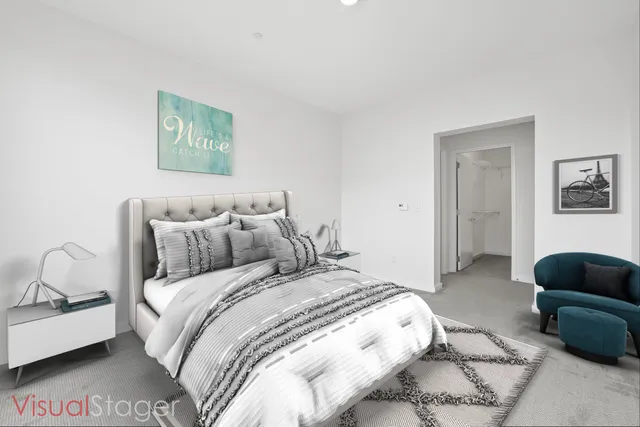 a bedroom with bed couch and window