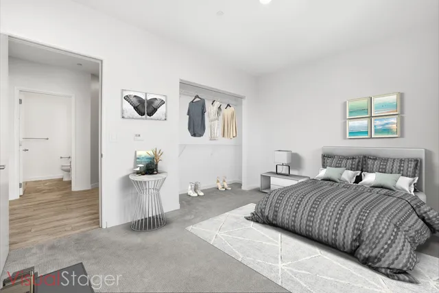 a bedroom with a large bed and painting on the wall