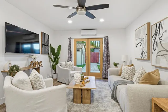 a living room with furniture and a flat screen tv