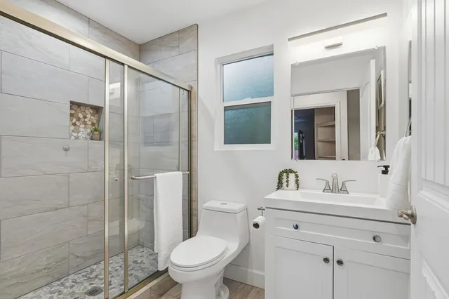 a bathroom with a sink toilet and shower