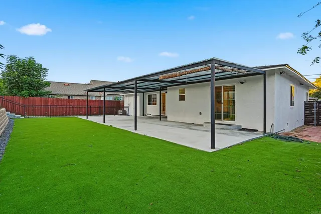 a house with green field in front of it