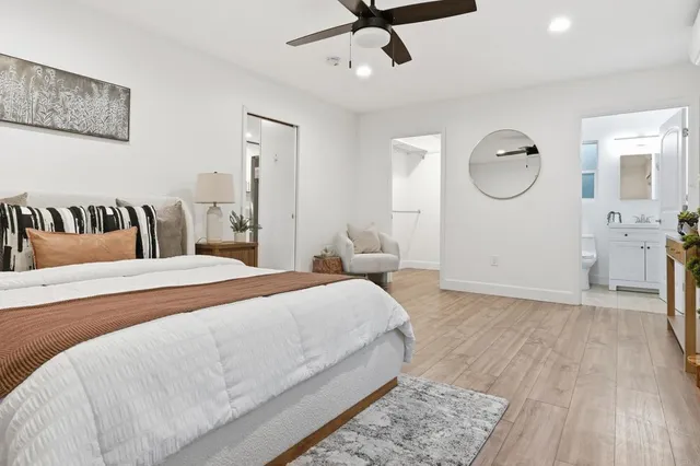 a bedroom with a bed and wooden floor