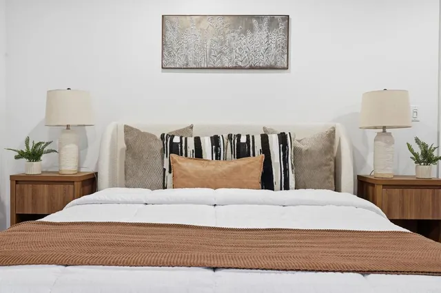 a large white bed in a white room