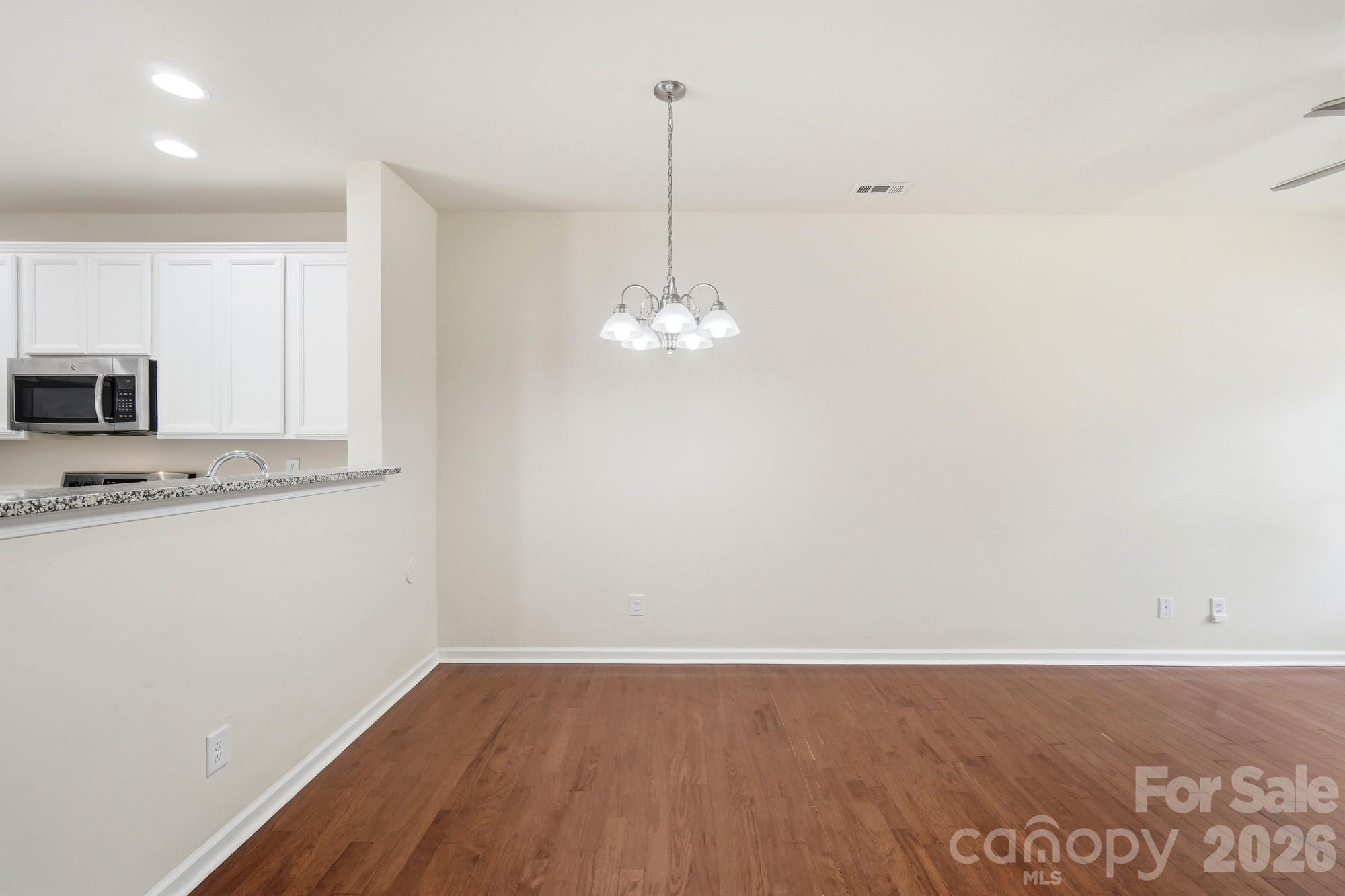 175 Limerick Road, Unit B Mooresville, NC 28115 - Photo 7 of 30 a view of a kitchen with center island and wooden floor