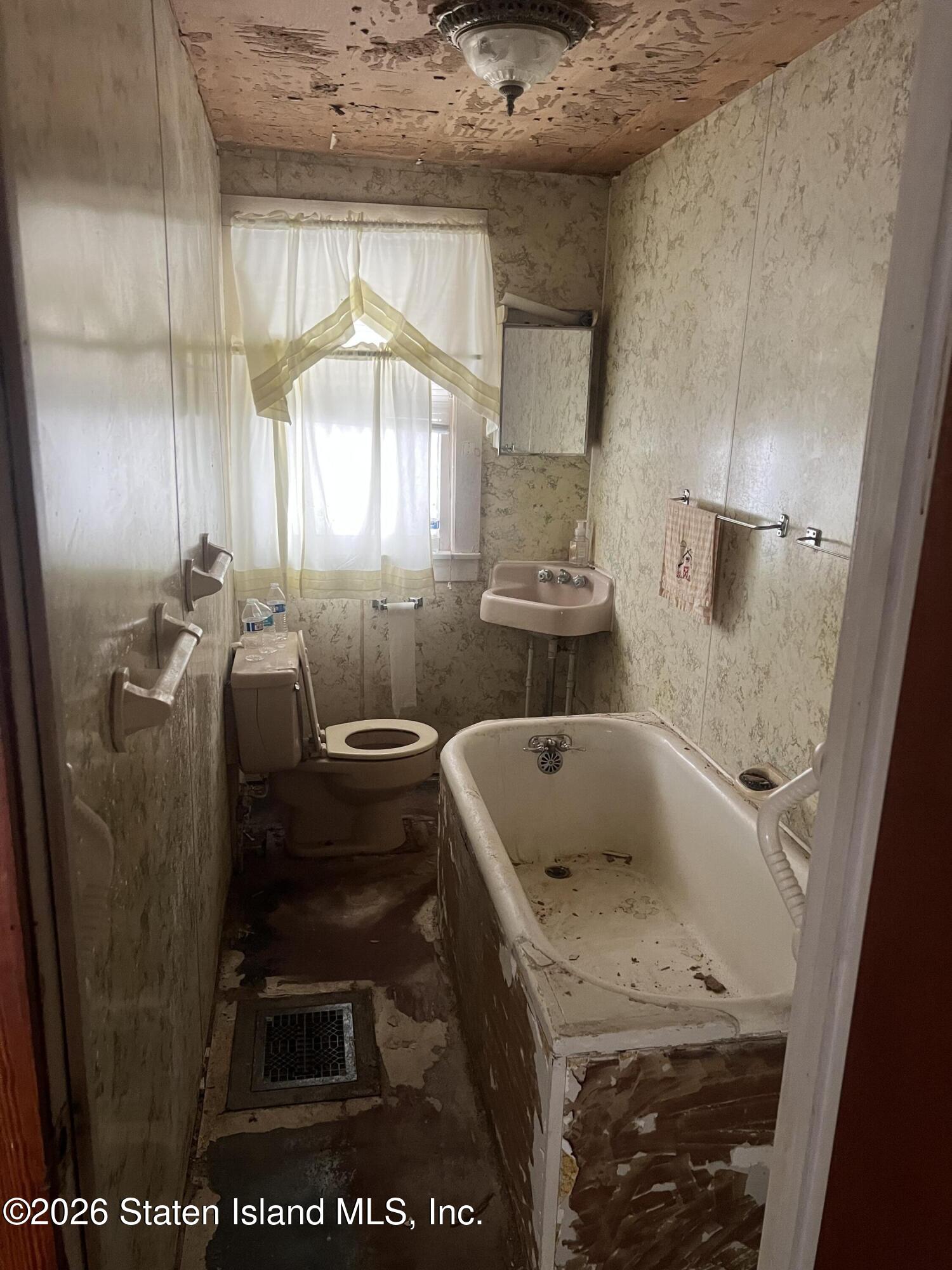 634 Drumgoole Road East Staten Island, NY 10312 - Photo 7 of 10 a bathroom with a granite countertop sink a toilet and a shower