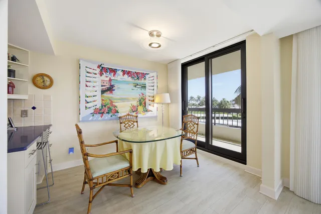 a view of a dining room with furniture and a floor to ceiling window