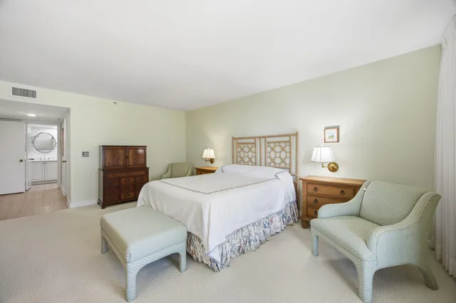 a bedroom with a bed and chair