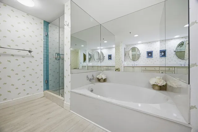 a bathroom with a bathtub and a shower