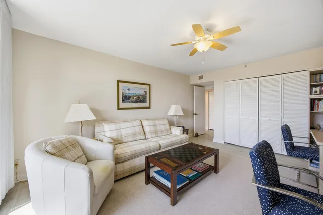 a living room with furniture a chandelier and a window