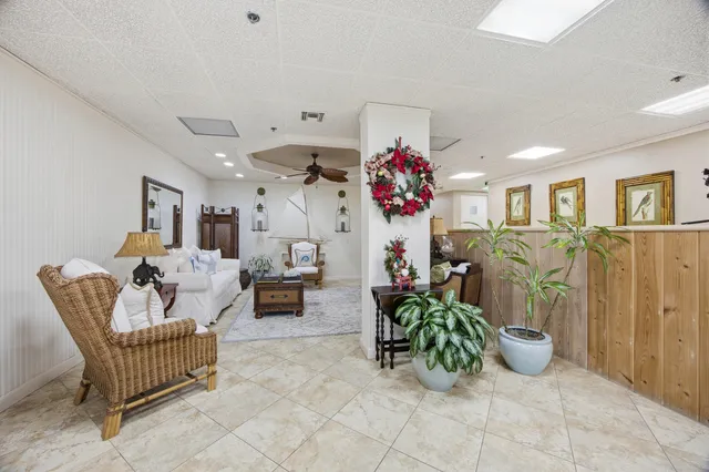 a living room with furniture and a chandelier